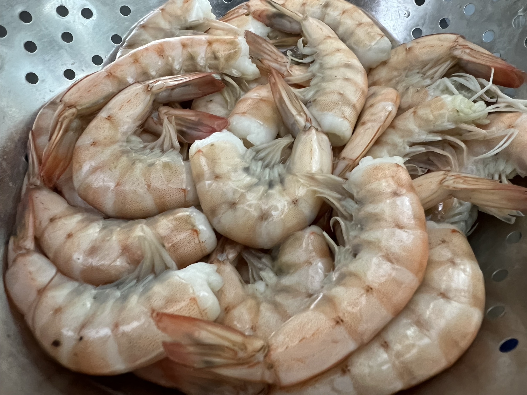 collander with cooked shrimp